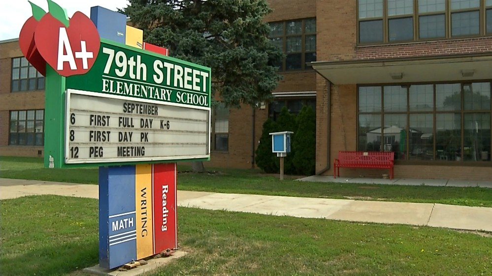 Green sign that reads 79th Street School